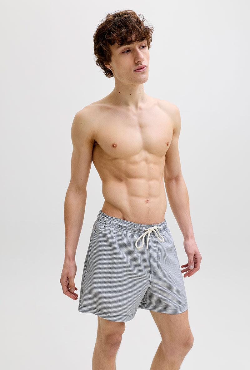 Front image of a model wearing Maui ocean seersucker swimshorts in navy, by brand Jack&jones