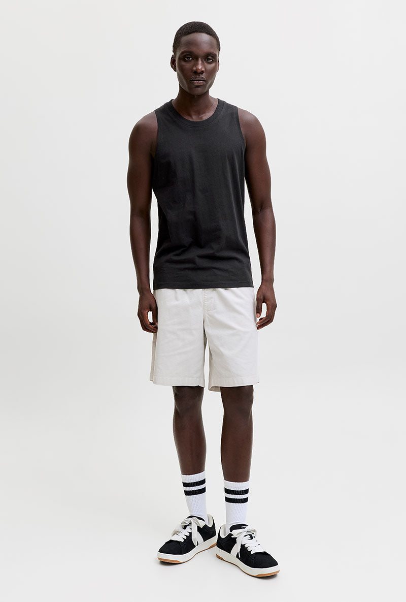 Front image of a model wearing Sunset back print sleeveless tshirt in black, by brand Jack&jones