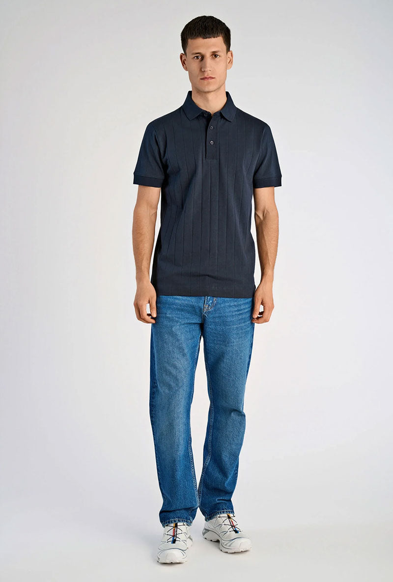 Front image of a model wearing Needle drop s/s polo in navy, by brand Lindbergh