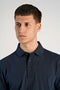 Front image of a model wearing the Needle drop s/s polo in navy, by brand Lindbergh