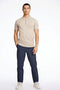 Front image of a model wearing the Ecovero s/s knit polo in sand, by brand Lindbergh