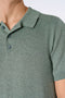 Front image of a model wearing the Ecovero s/s knit polo in light green, by brand Lindbergh