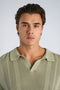 Front image of a model wearing the Knitted s/s polo in light green, by brand Lindbergh