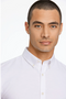Front detail image of a model wearing the Oxford superflex l/s shirt in white, by brand Lindbergh
