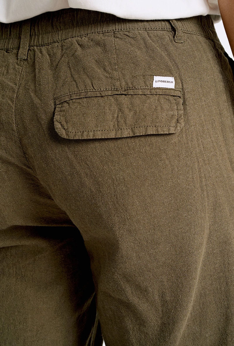 Back image of a model wearing Relaxed fit linen trousers in khaki, by brand Lindbergh