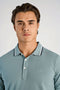 Front image of a model wearing the S/s contrast polo in aqua, by brand Lindbergh