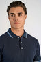 Front image of a model wearing the S/s contrast polo in navy, by brand Lindbergh