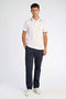 Front image of a model wearing the S/s contrast polo in white, by brand Lindbergh