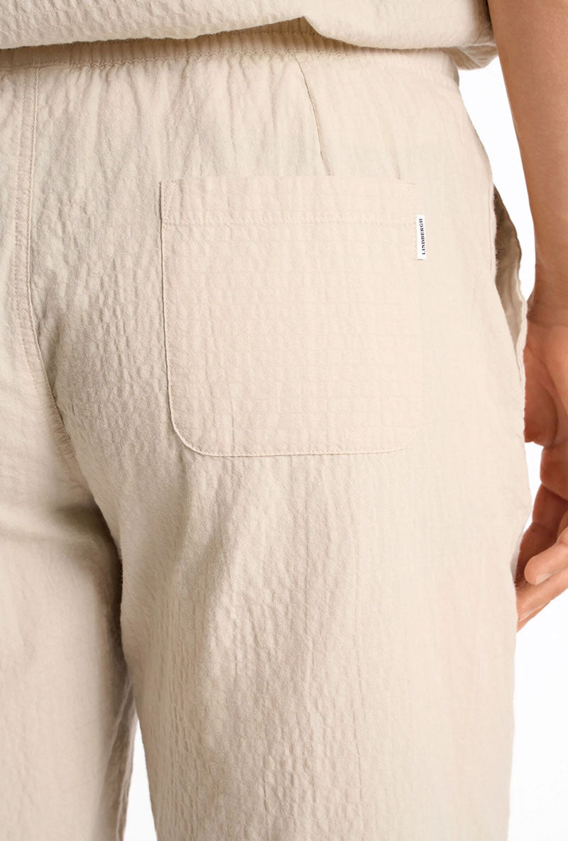 Back detail image of a model wearing Seersucker shorts in beige, by brand Lindbergh