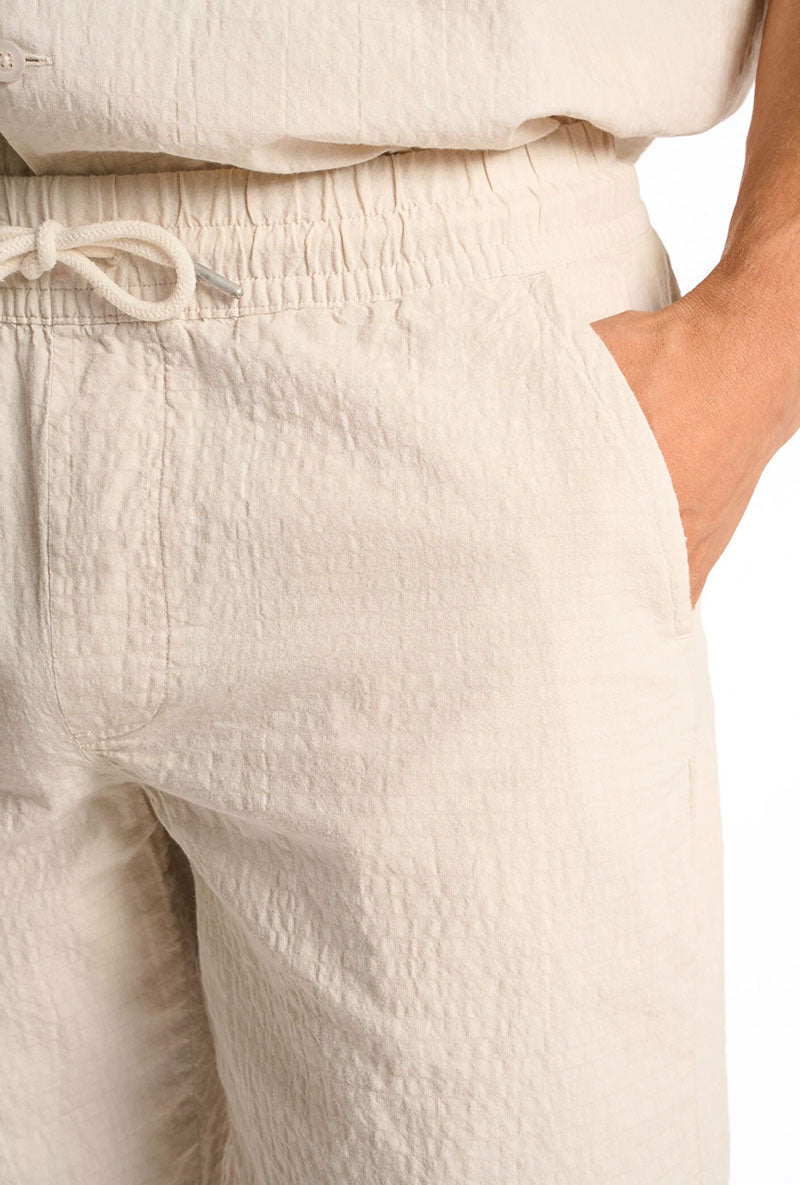 Front detail image of a model wearing Seersucker shorts in beige, by brand Lindbergh