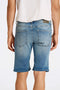 Back image of a model wearing the Superflex denim shorts in dark denim, by brand Lindbergh