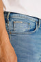 Front image of a model wearing the Superflex denim shorts in dark denim, by brand Lindbergh