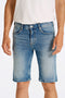 Front image of a model wearing the Superflex denim shorts in dark denim, by brand Lindbergh