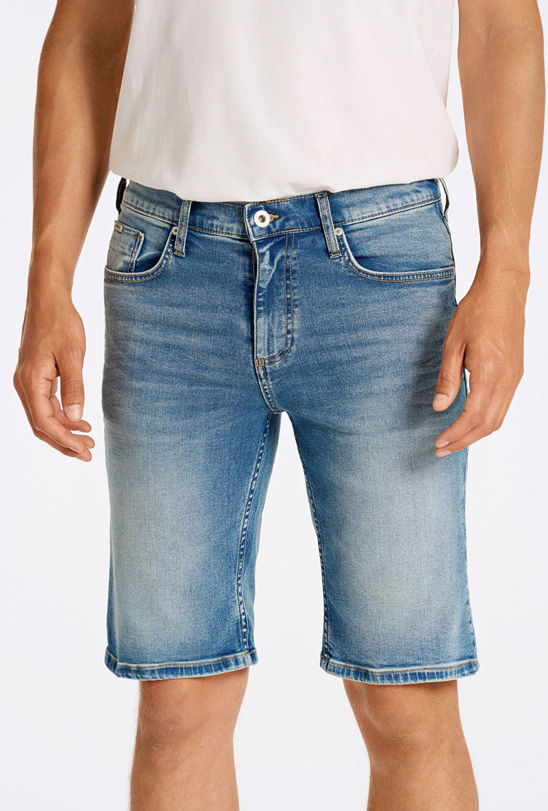 Front image of a model wearing Superflex denim shorts in dark denim, by brand Lindbergh