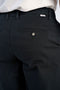Back image of a model wearing the Superflex relaxed fit chino pants in black, by brand Lindbergh