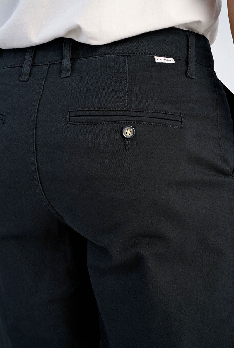 Back image of a model wearing Superflex relaxed fit chino pants in black, by brand Lindbergh