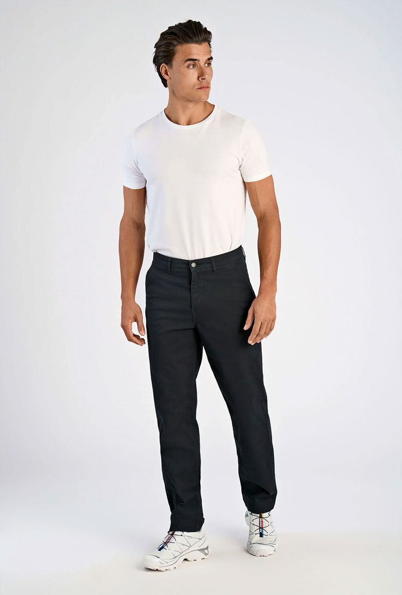 Front image of a model wearing Superflex relaxed fit chino pants in black, by brand Lindbergh