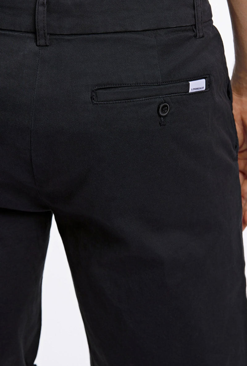 Back detail image of a model wearing Superflex relaxed fit chino shorts in black, by brand Lindbergh