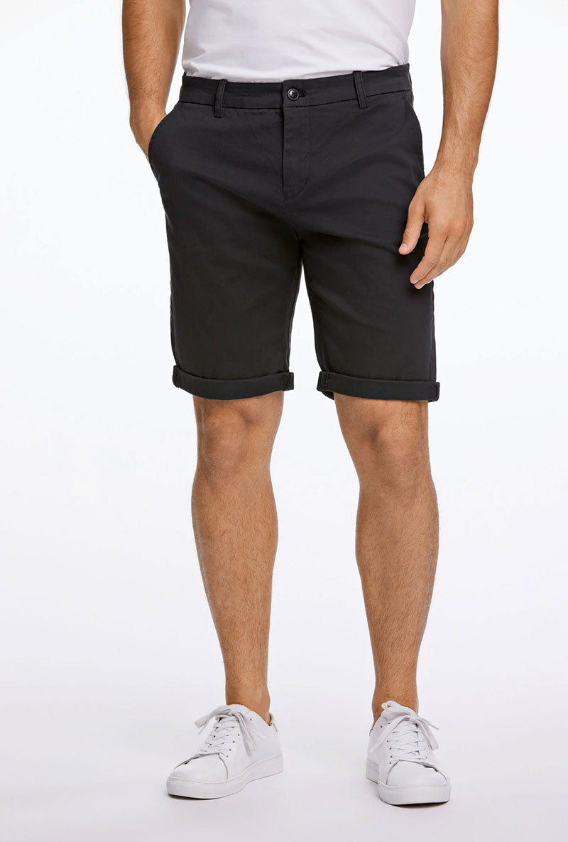 Front image of a model wearing Superflex relaxed fit chino shorts in black, by brand Lindbergh