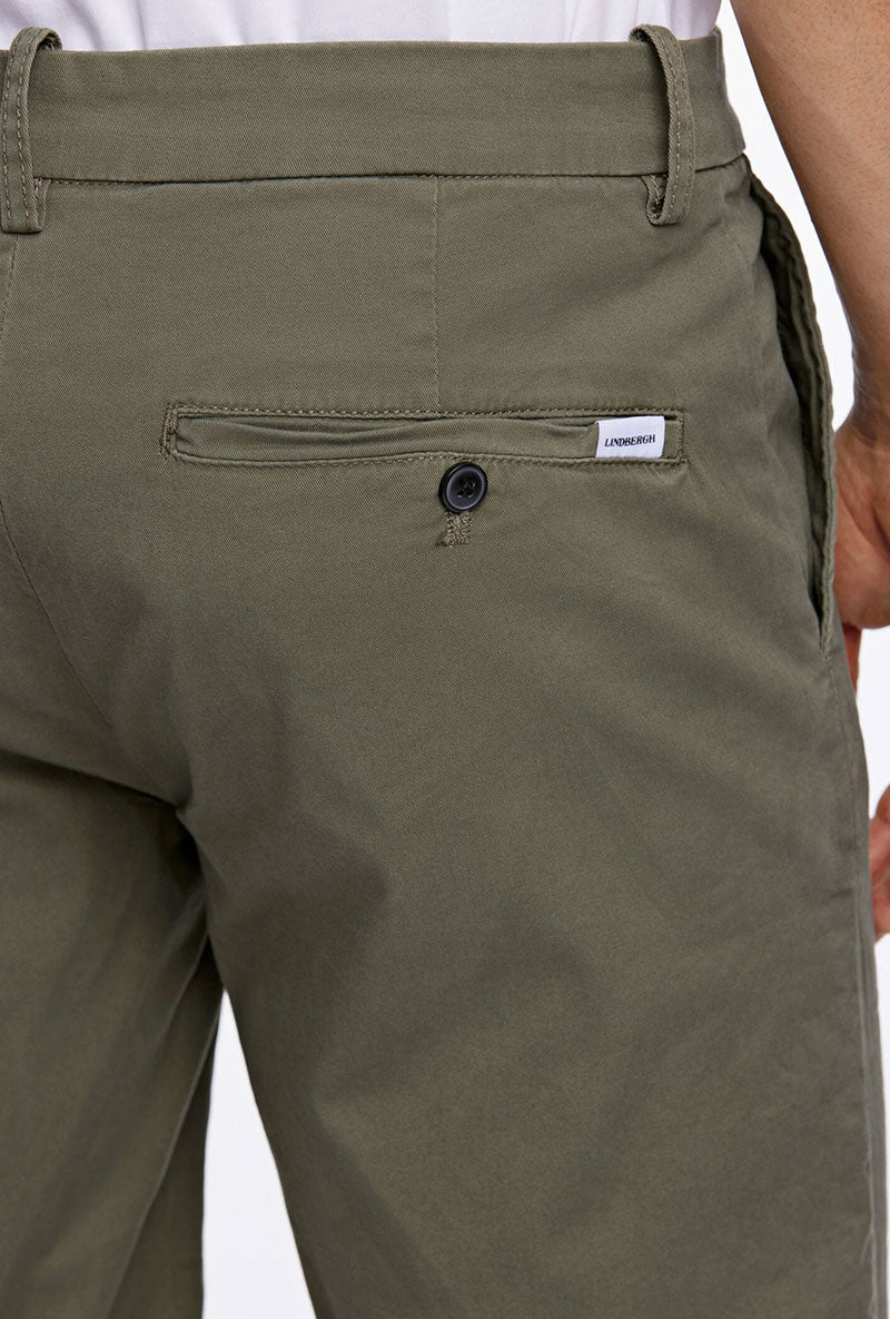 Back detail image of a model wearing Superflex relaxed fit chino shorts in khaki, by brand Lindbergh