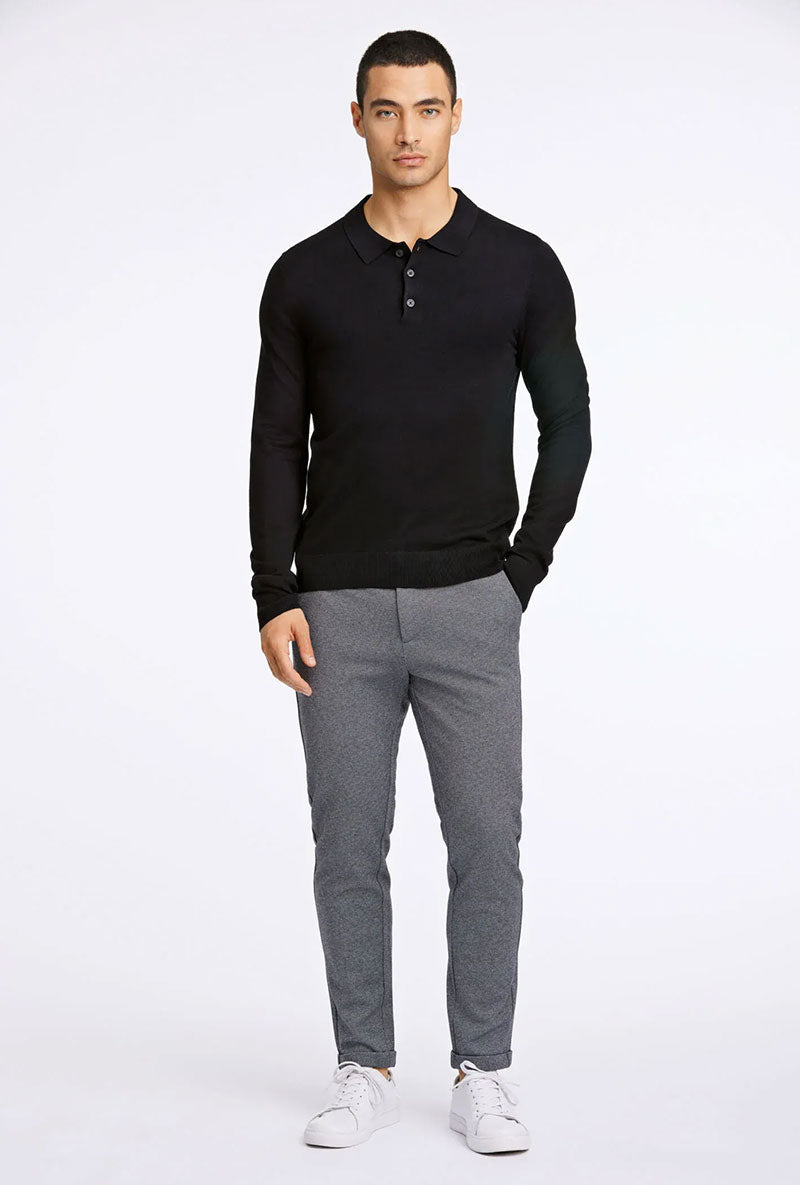 Front image of a model wearing Ecovero ls polo in black, by brand Lindbergh