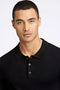 Front image of a model wearing the Ecovero ls polo in black, by brand Lindbergh