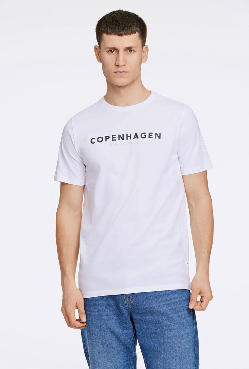 Front image of a model wearing Lindbergh logo print ss tshirt in white, by brand Lindbergh