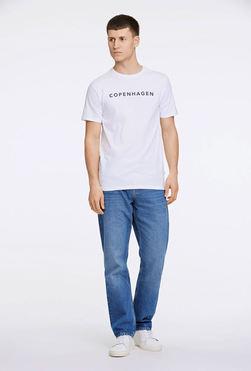 Front image of a model wearing Lindbergh logo print ss tshirt in white, by brand Lindbergh