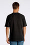 Back image of a model wearing the Oneck oversize tshirt in black, by brand Lindbergh