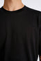 Front image of a model wearing the Oneck oversize tshirt in black, by brand Lindbergh