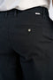 Back image of a model wearing the Superflex chino pants in black, by brand Lindbergh