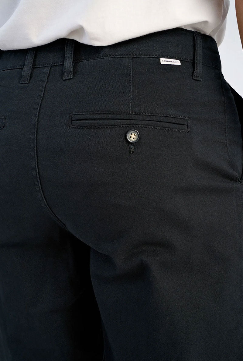 Back image of a model wearing Superflex chino pants in black, by brand Lindbergh