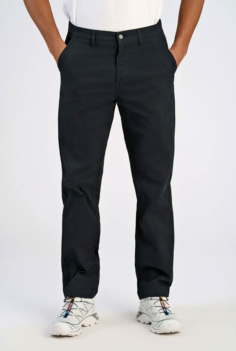 Front image of a model wearing Superflex chino pants in black, by brand Lindbergh