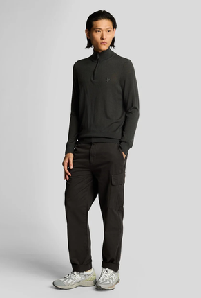 Front image of a model wearing Lyle and scott cargo pocket trousers in black, by brand Lyle and scott