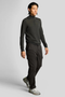 Front image of a model wearing the Lyle and scott cargo pocket trousers in black, by brand Lyle and scott