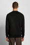Back image of a model wearing the Lyle and scott merino v neck cardigan in black, by brand Lyle and scott