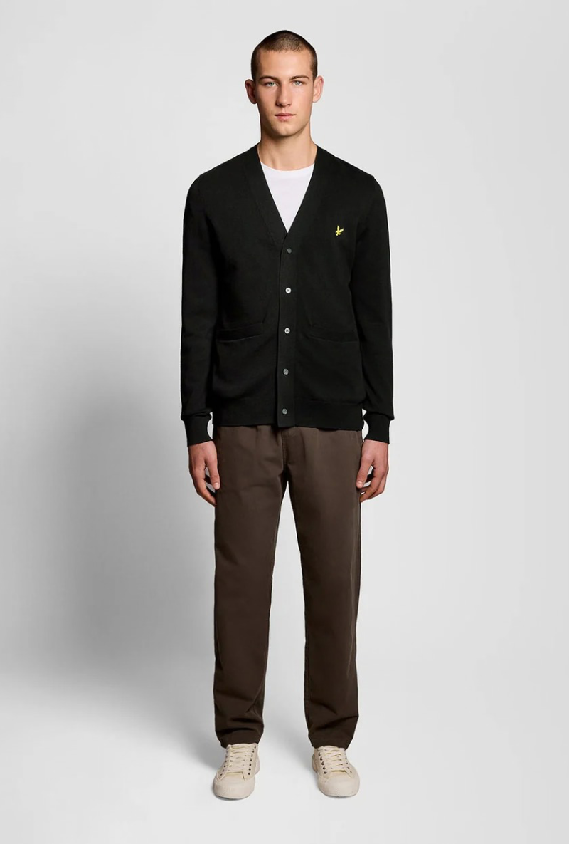 Front image of a model wearing Lyle and scott merino v neck cardigan in black, by brand Lyle and scott