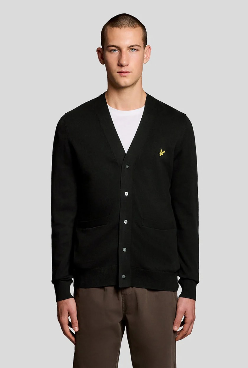Front image of a model wearing Lyle and scott merino v neck cardigan in black, by brand Lyle and scott