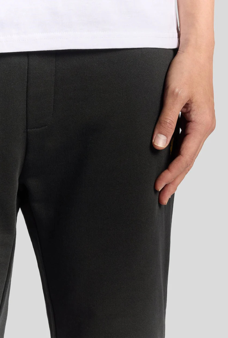 Front detail image of a model wearing Lyle and scott straight leg jogger in black, by brand Lyle and scott
