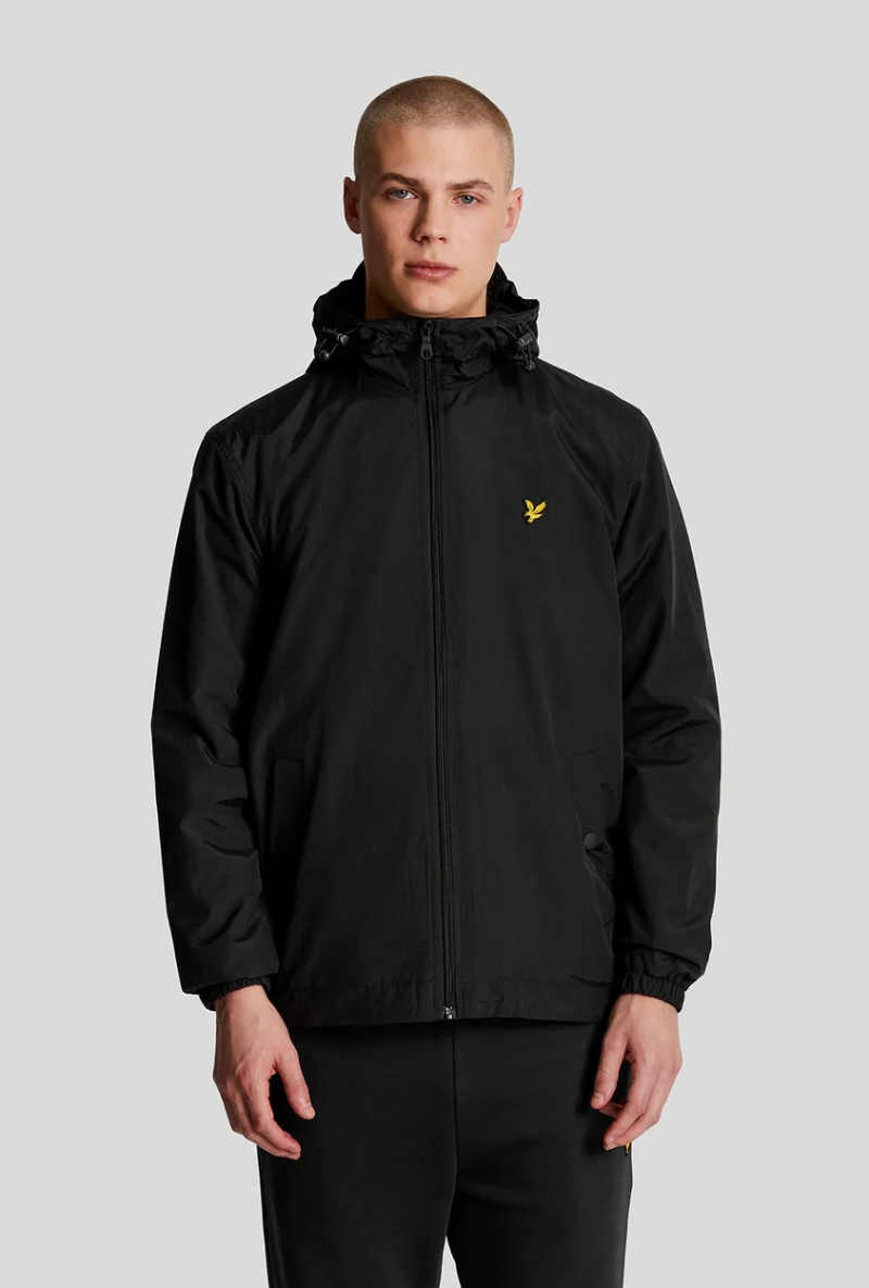 Front image of a model wearing Lyle and scott zip through hooded jacket in black, by brand Lyle and scott