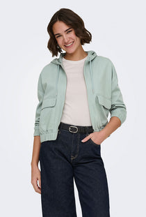 Front image of a model wearing the Kenzie soft life jacket in light green, by brand Only