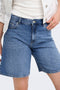 Front image of a model wearing the Lumi mw mom shorts in denim, by brand Only