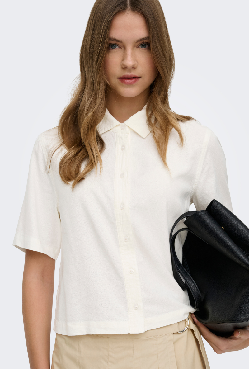 Front image of a model wearing Goa shortsleeve linen shirt in off white, by brand Only