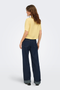 Back image of a model wearing the Goa shortsleeve linen shirt in yellow, by brand Only