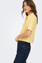 Front detail image of a model wearing the Goa shortsleeve linen shirt in yellow, by brand Only