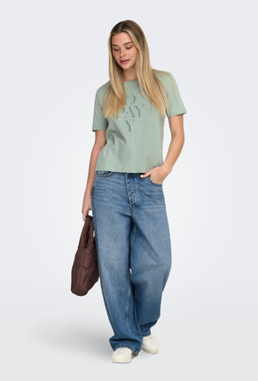 Front image of a model wearing Only happy s/s print top in sage, by brand Only