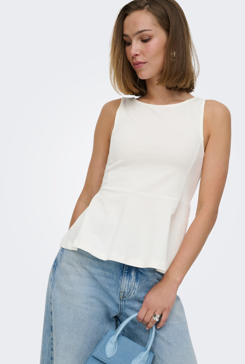 Front image of a model wearing Kiss sleeveless peplum top in white, by brand Only