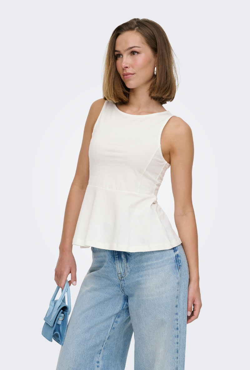 Front image of a model wearing Kiss sleeveless peplum top in white, by brand Only