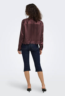 Back image of a model wearing the Lindona l/s satin lace shirt in chocolate, by brand Only