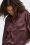Front image of a model wearing the Lindona l/s satin lace shirt in chocolate, by brand Only